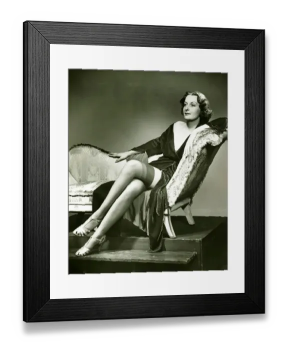Framed Print : Fashionable woman in stockings sitting on chaise longue, (B&W), portrait Framed Print : Fashionable woman in stockings sitting on chaise longue, (B&W), portrait