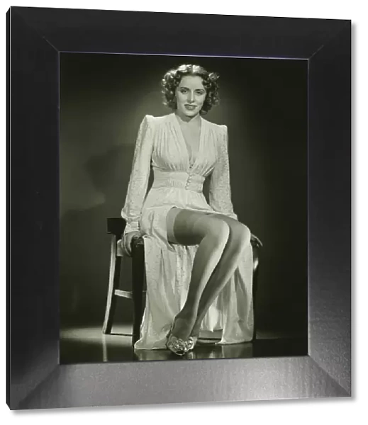 Young woman sitting on chair, posing, (B&W)