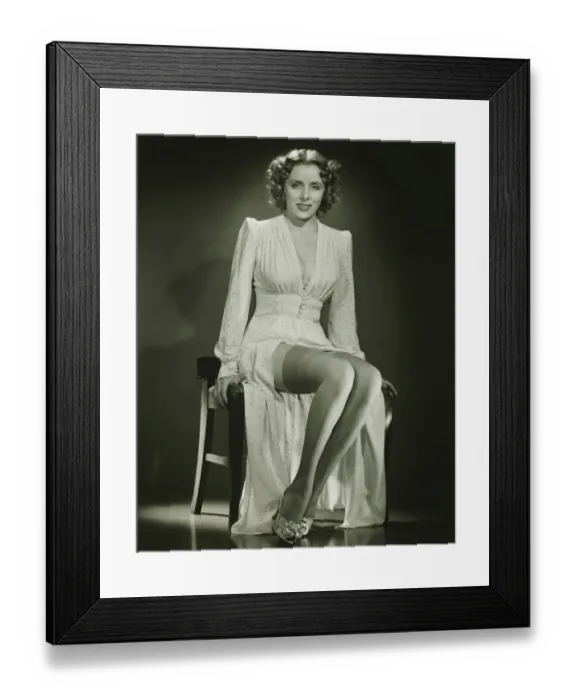 Framed Print : Young woman sitting on chair, posing, (B&W) Framed Print : Young woman sitting on chair, posing, (B&W)