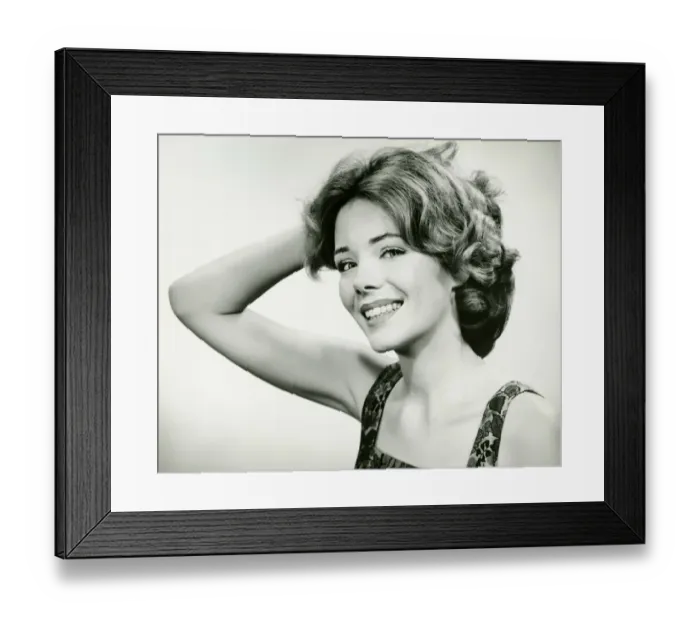 Framed Print : Young woman smiling, holding hand on head (B&W), (Portrait) Framed Print : Young woman smiling, holding hand on head (B&W), (Portrait)