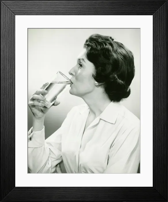 Framed Print : Woman drinking water, posing in studio, (B&W), (Portrait) Framed Print : Woman drinking water, posing in studio, (B&W), (Portrait)