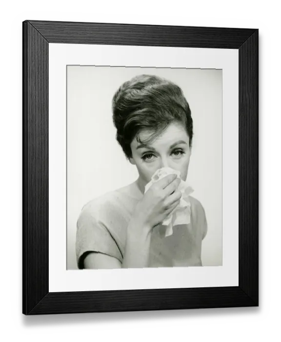 Framed Print : Young woman wiping nose with handkerchief, posing in studio, (B&W), (Portrait) Framed Print : Young woman wiping nose with handkerchief, posing in studio, (B&W), (Portrait)