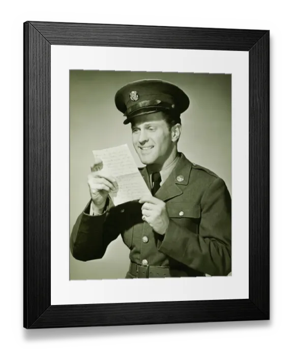 Framed Print : US Army solider reading letter in studio, (B&W), portrait Framed Print : US Army solider reading letter in studio, (B&W), portrait