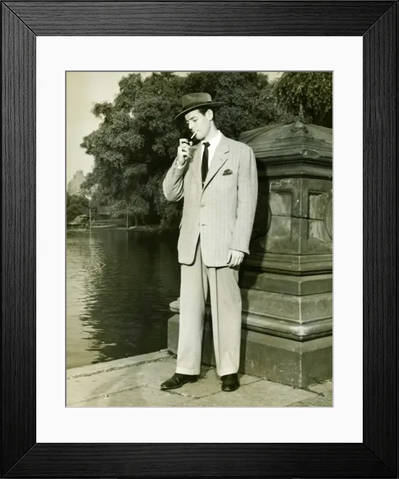 Framed Print : Man lighting cigarette by lake in park, (B&W) Framed Print : Man lighting cigarette by lake in park, (B&W)