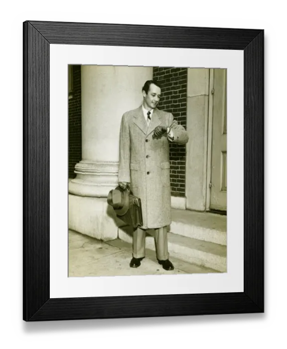 Framed Print : Elegant man checking watch at entrance to building, (B&W)