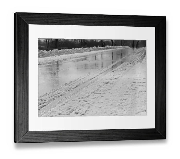 Framed Print : Snow-covered road in winter, with people in background