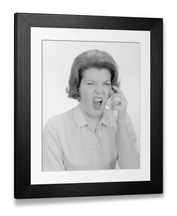 Framed Print : Studio portrait of mid adult woman sneezing Framed Print : Studio portrait of mid adult woman sneezing