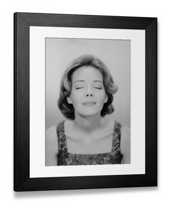 Framed Print : Studio shot of young woman with eyes closed Framed Print : Studio shot of young woman with eyes closed