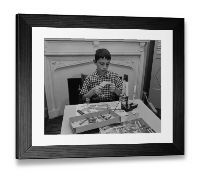 Framed Print : Boy (12-13) making space rocket model in living room Framed Print : Boy (12-13) making space rocket model in living room