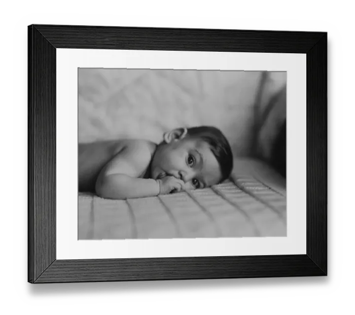Framed Print : Portrait of baby boy (6-11 months) lying on front with fingers in mouth Framed Print : Portrait of baby boy (6-11 months) lying on front with fingers in mouth