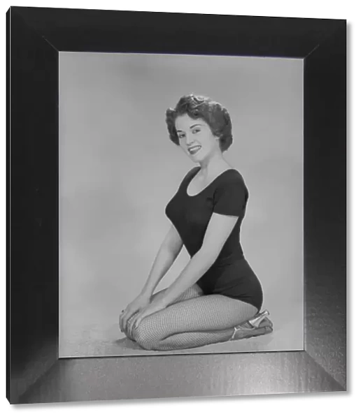 Portrait of young woman kneeling