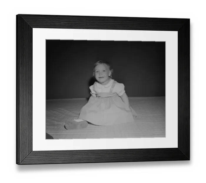 Framed Print : Portrait of baby girl (18-23 months) sitting on bed