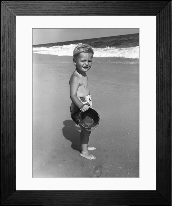 Framed Print : Portrait of boy (4-5) at seashore with bucket Framed Print : Portrait of boy (4-5) at seashore with bucket
