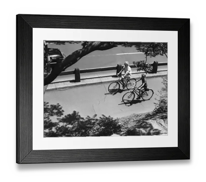 Framed Print : Elevated view of man and boy (12-13) cycling Framed Print : Elevated view of man and boy (12-13) cycling