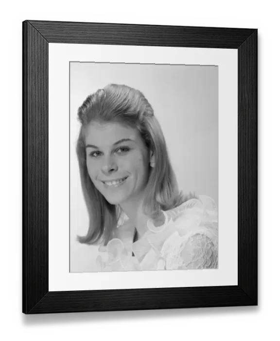Framed Print : Studio portrait of young woman smiling Framed Print : Studio portrait of young woman smiling