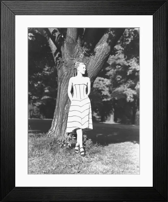 Framed Print : Young woman leaning on tree in park, (B&W) Framed Print : Young woman leaning on tree in park, (B&W)