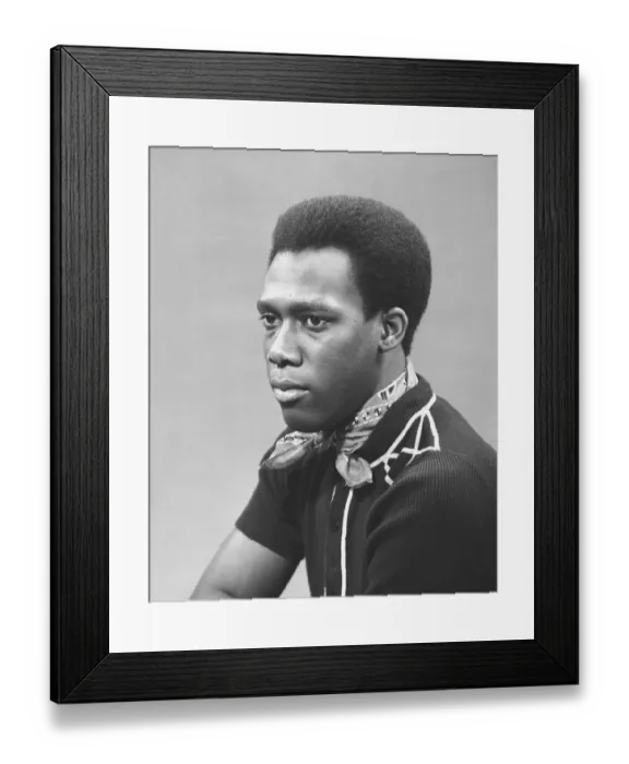 Framed Print : Man with scarf posing in studio, (B&W), portrait Framed Print : Man with scarf posing in studio, (B&W), portrait
