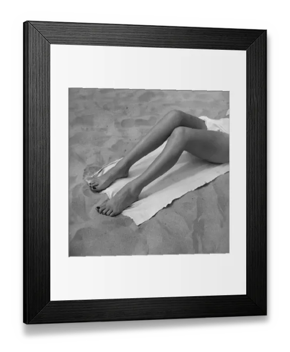 Framed Print : Woman sun tanning on beach, (B&W), , low section Framed Print : Woman sun tanning on beach, (B&W), , low section