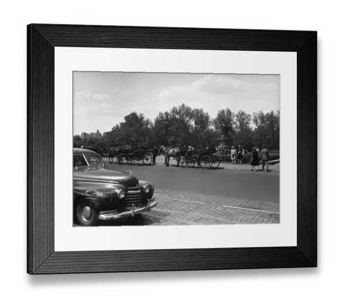 Framed Print : Car riding on street along park, horse carriages on other side, (B&W) Framed Print : Car riding on street along park, horse carriages on other side, (B&W)