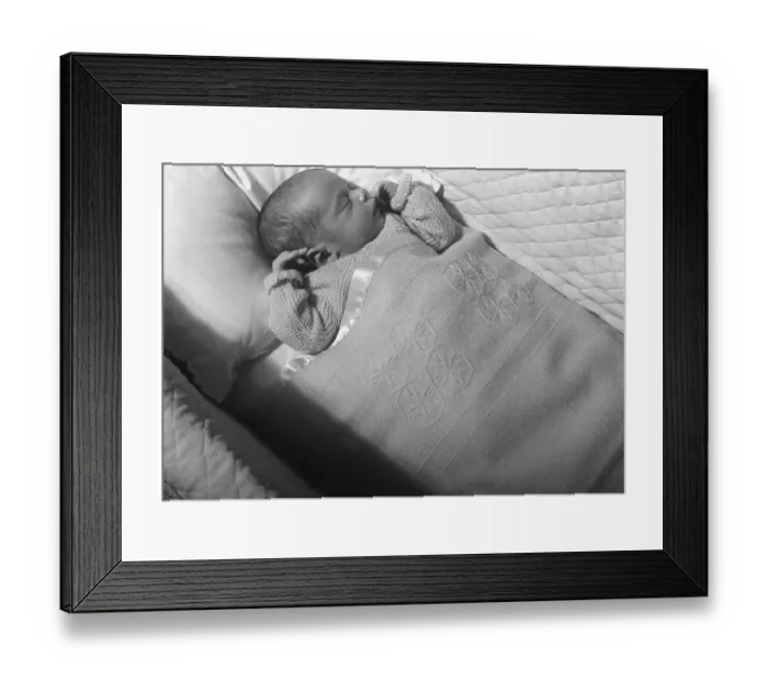 Framed Print : Baby (0-3 months) lying in crib, sleeping, (B&W), elevated view Framed Print : Baby (0-3 months) lying in crib, sleeping, (B&W), elevated view