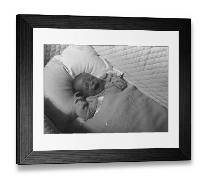 Framed Print : Baby (0-3 months) lying in crib, crying, (B&W), elevated view