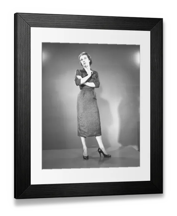 Framed Print : Woman with arms crossed in studio, (B&W) Framed Print : Woman with arms crossed in studio, (B&W)