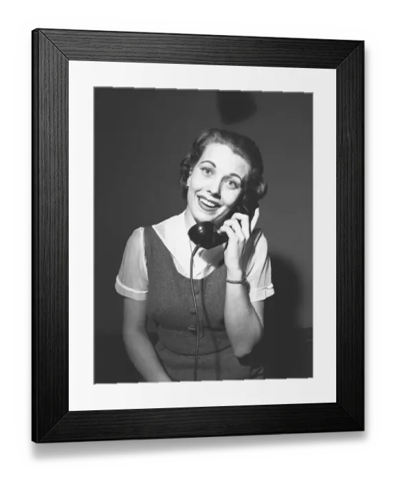 Framed Print : Smiling woman talking on phone, (B&W), portrait