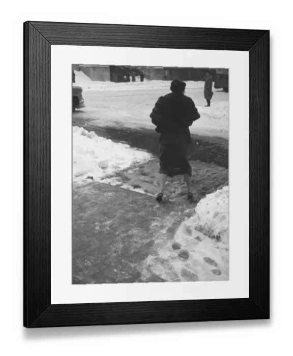 Framed Print : Woman crossing street in winter, (B&W), (rear view) Framed Print : Woman crossing street in winter, (B&W), (rear view)