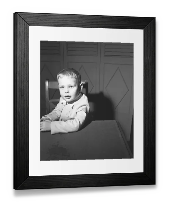 Framed Print : Boy (3-4) sitting at table, (B&W), portrait Framed Print : Boy (3-4) sitting at table, (B&W), portrait