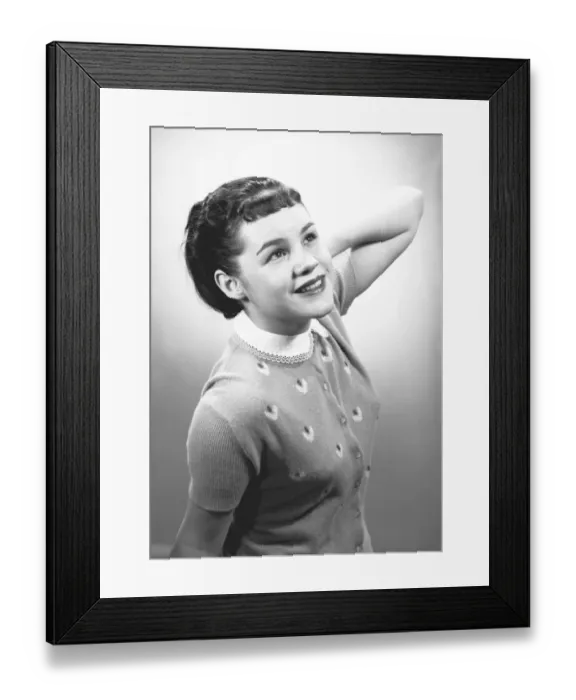 Framed Print : Young woman posing in studio, (B&W), portrait Framed Print : Young woman posing in studio, (B&W), portrait