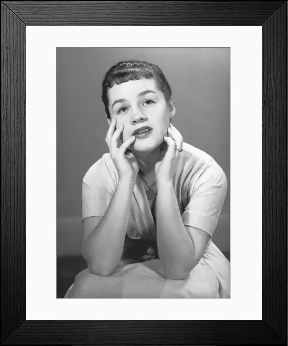 Framed Print : Pensive woman in white dress posing in studio, (B&W), portrait Framed Print : Pensive woman in white dress posing in studio, (B&W), portrait