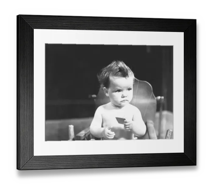 Framed Print : Baby (9-12 months) sitting in high chair, (B&W) Framed Print : Baby (9-12 months) sitting in high chair, (B&W)