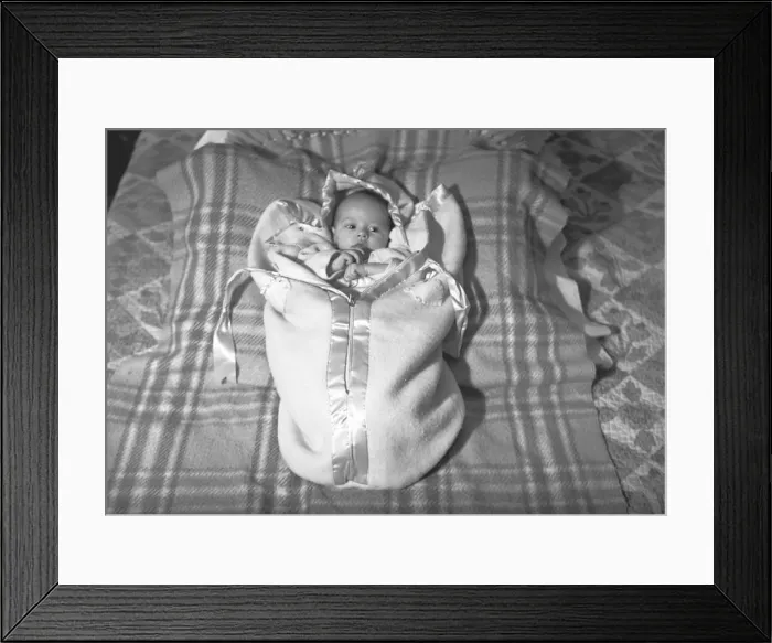 Framed Print : Baby (3-6 months) lying on blanket, (B&W), elevated view Framed Print : Baby (3-6 months) lying on blanket, (B&W), elevated view