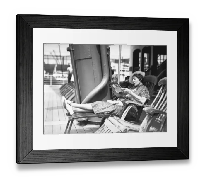 Framed Print : Woman reading magazine on cruiser deck, (B&W) Framed Print : Woman reading magazine on cruiser deck, (B&W)