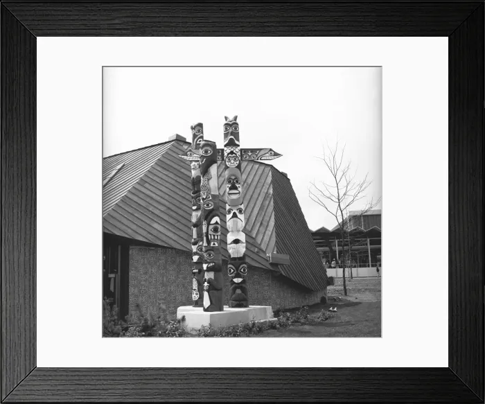 Framed Print : Totem poles at building, (B&W) Framed Print : Totem poles at building, (B&W)