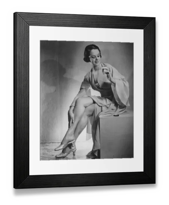 Framed Print : Woman holding perfume bottle in studio (B&W) Framed Print : Woman holding perfume bottle in studio (B&W)