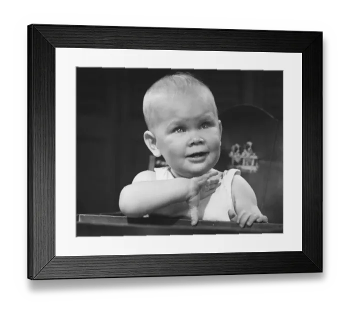 Framed Print : Baby boy (6-9 months) sitting in highchair (B&W)