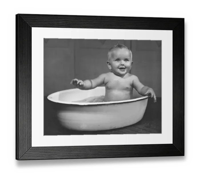 Framed Print : Baby boy (6-9 months) bathing in basin (B&W) Framed Print : Baby boy (6-9 months) bathing in basin (B&W)