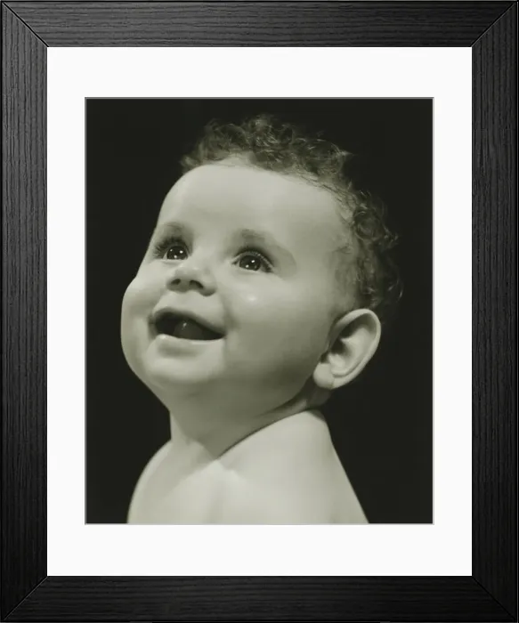 Framed Print : Baby (6-9 months) posing in studio, (B&W), portrait Framed Print : Baby (6-9 months) posing in studio, (B&W), portrait