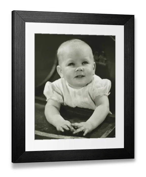 Framed Print : Girl (6-9 months) sitting in high chair, (B&W) Framed Print : Girl (6-9 months) sitting in high chair, (B&W)
