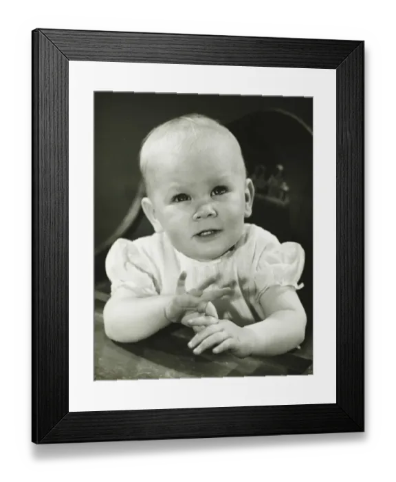 Framed Print : Girl (6-9 months) sitting in high chair, (B&W) Framed Print : Girl (6-9 months) sitting in high chair, (B&W)