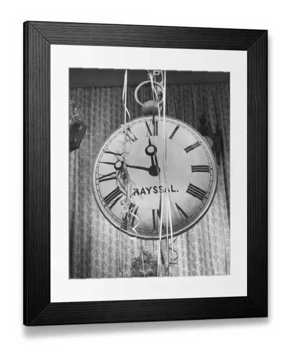 Framed Print : Wall clock covered in party streamers, (B&W) Framed Print : Wall clock covered in party streamers, (B&W)