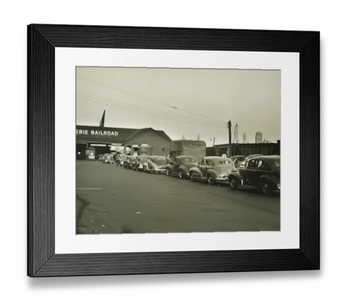 Framed Print : Row of cars in front of railway station, (B&W) Framed Print : Row of cars in front of railway station, (B&W)