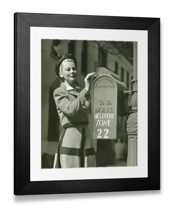 Framed Print : Woman putting letter into mailbox, (B&W) Framed Print : Woman putting letter into mailbox, (B&W)