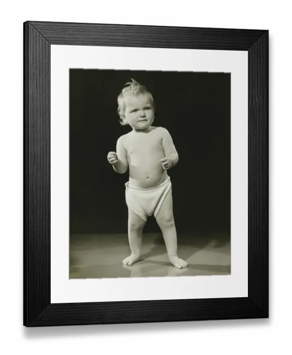 Framed Print : Baby (12-15 months) in diaper standing in studio, (B&W) Framed Print : Baby (12-15 months) in diaper standing in studio, (B&W)