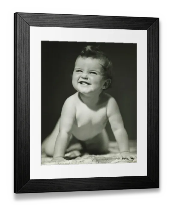 Framed Print : Baby girl (6-9 months) crawling on blanket in studio, (B&W)