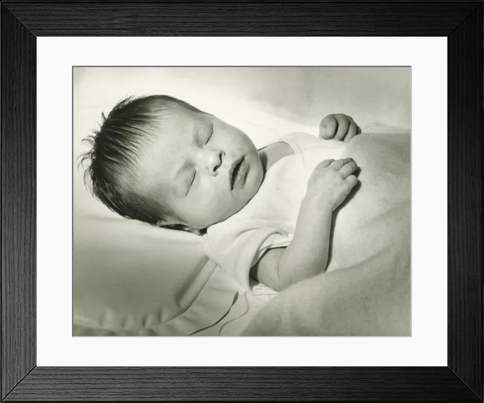 Framed Print : Newborn (0-3 months) sleeping in crib, (B&W) Framed Print : Newborn (0-3 months) sleeping in crib, (B&W)