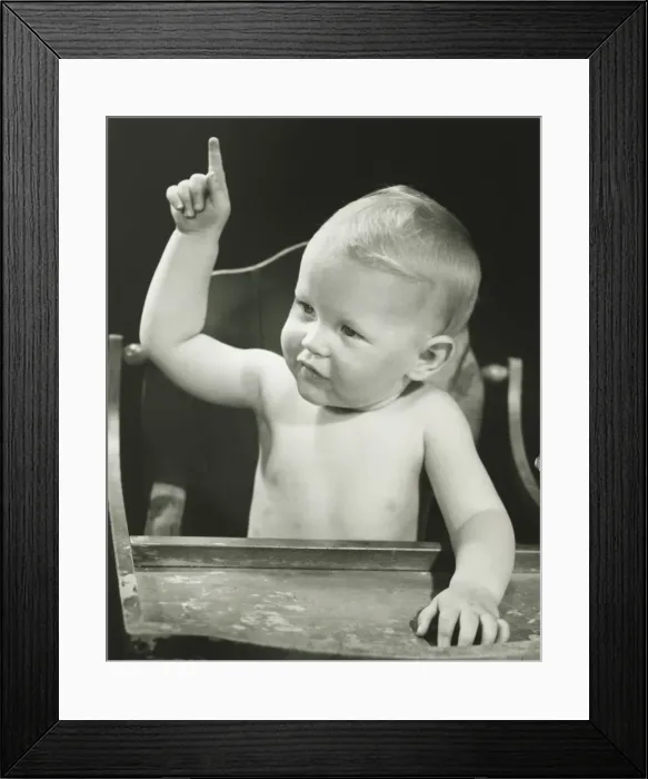 Framed Print : Baby boy (6-12 months) pointing, sitting in high chair, (B&W), portrait Framed Print : Baby boy (6-12 months) pointing, sitting in high chair, (B&W), portrait