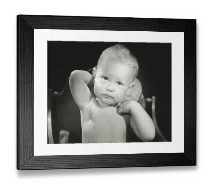 Framed Print : Baby boy (6-12 months) sitting in high chair, (B&W), portrait Framed Print : Baby boy (6-12 months) sitting in high chair, (B&W), portrait