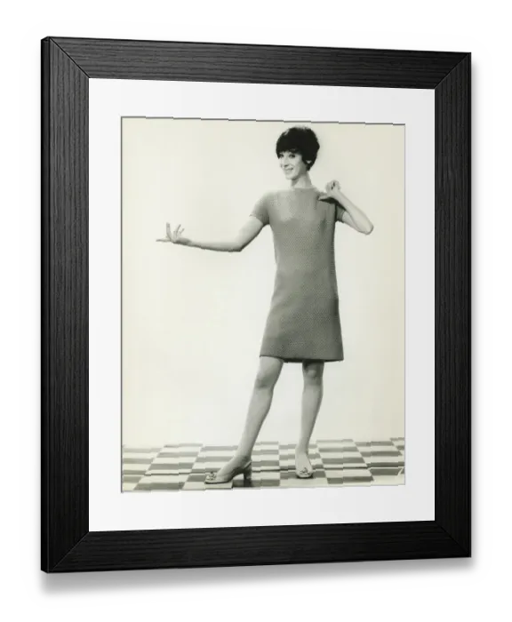 Framed Print : Woman in knitted dress gesturing in studio, (B&W), portrait Framed Print : Woman in knitted dress gesturing in studio, (B&W), portrait